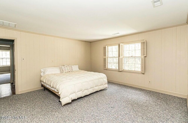 322 Gravley Dr, Rocky Mount, NC 27804 - carpeted bedroom with wooden walls