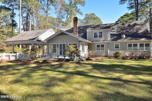 322 Gravley Dr, Rocky Mount, NC 27804 - rear view of house with a chimney and a wooden deck