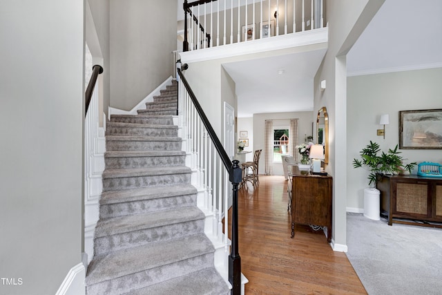 8841 Deerland Grove Dr, Raleigh, NC 27615 - staircase featuring wood finished floors and ornamental molding