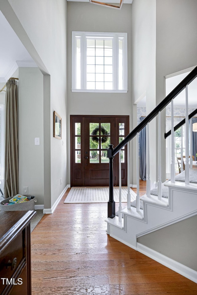 8841 Deerland Grove Dr, Raleigh, NC 27615 - foyer entrance featuring a high ceiling, stairs, and hardwood / wood-style flooring
