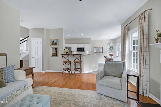 8841 Deerland Grove Dr, Raleigh, NC 27615 - living room with light wood-type flooring, stairway, and recessed lighting