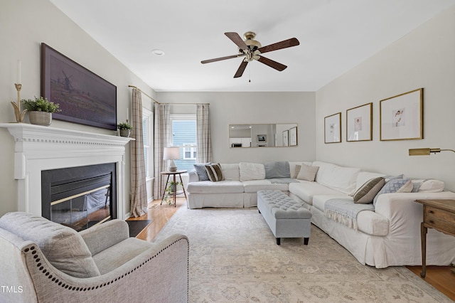 8841 Deerland Grove Dr, Raleigh, NC 27615 - living area with wood finished floors, ceiling fan, and a glass covered fireplace