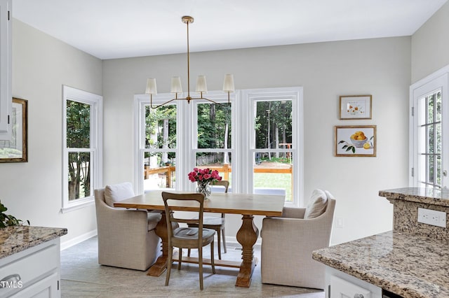 8841 Deerland Grove Dr, Raleigh, NC 27615 - dining room featuring a chandelier and light tile patterned floors