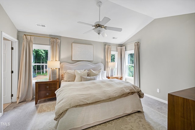 8841 Deerland Grove Dr, Raleigh, NC 27615 - bedroom with light carpet, multiple windows, lofted ceiling, and a ceiling fan