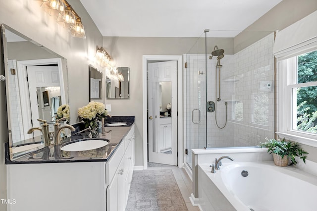 8841 Deerland Grove Dr, Raleigh, NC 27615 - bathroom featuring a stall shower, double vanity, and a bath
