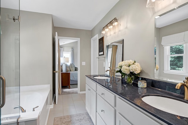 8841 Deerland Grove Dr, Raleigh, NC 27615 - ensuite bathroom featuring double vanity, a garden tub, and tile patterned floors