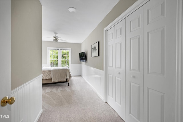 8841 Deerland Grove Dr, Raleigh, NC 27615 - carpeted bedroom featuring wainscoting, a closet, and a ceiling fan
