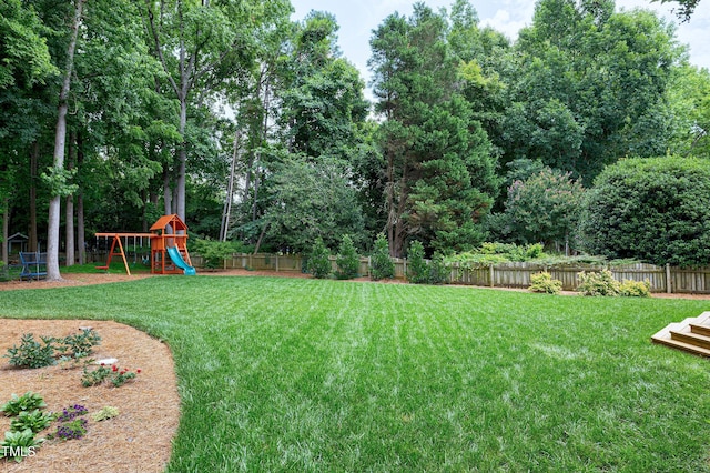 8841 Deerland Grove Dr, Raleigh, NC 27615 - fenced backyard with a playground