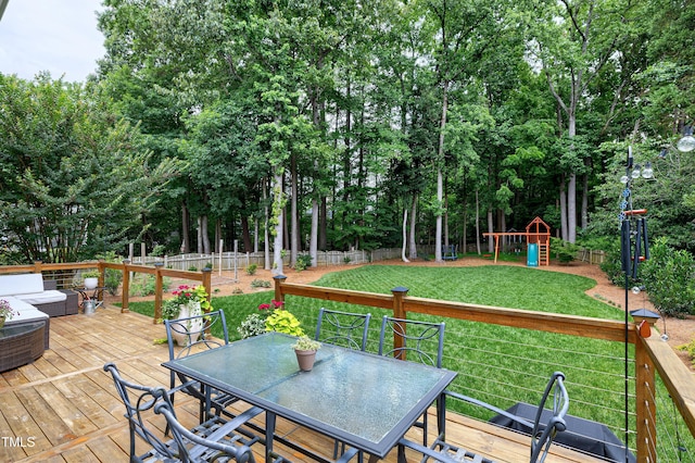8841 Deerland Grove Dr, Raleigh, NC 27615 - wooden terrace with outdoor dining space, a fenced backyard, and a playground