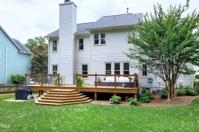 8841 Deerland Grove Dr, Raleigh, NC 27615 - back of house featuring a wooden deck, a lawn, a chimney, and a shingled roof