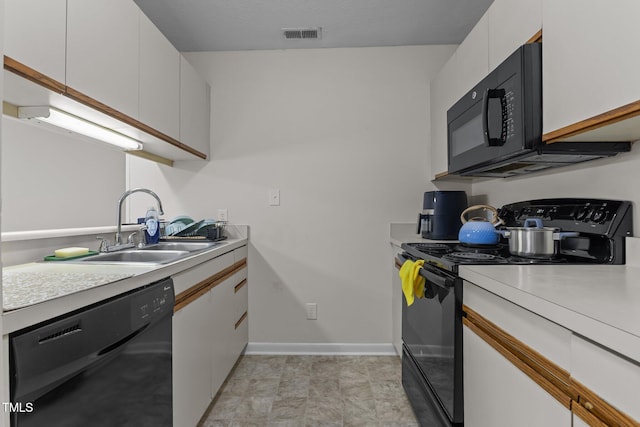 667 Bartons Lndg Unit 8, Fayetteville, NC 28314 - kitchen featuring black appliances, light countertops, and white cabinets