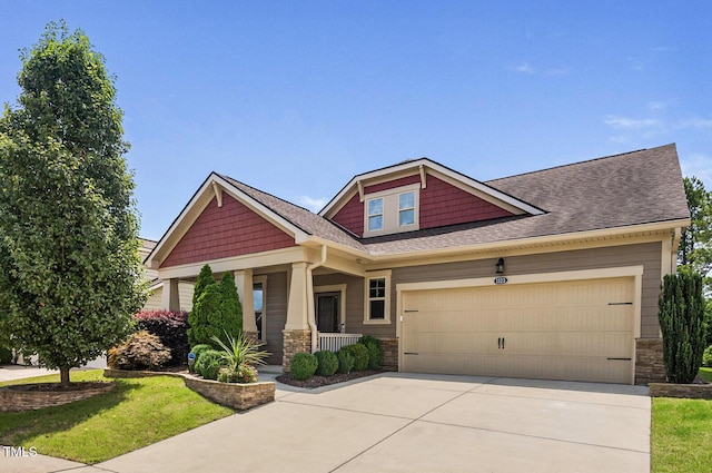 1523 Anthology Dr, Durham, NC 27703 - craftsman-style home with stone siding, a porch, driveway, an attached garage, and a shingled roof