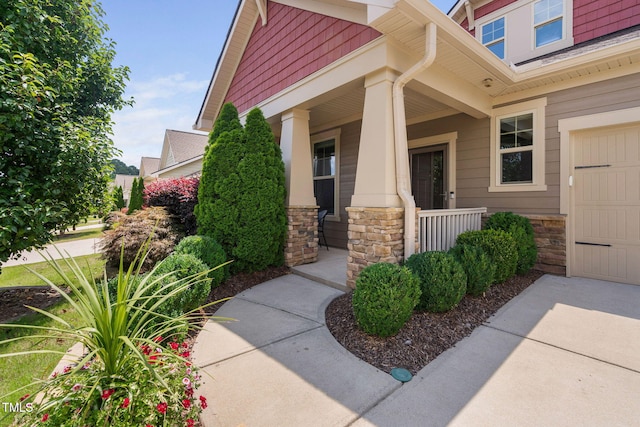 1523 Anthology Dr, Durham, NC 27703 - property entrance featuring stone siding, a porch, and a garage
