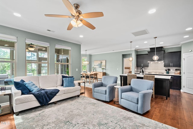 1523 Anthology Dr, Durham, NC 27703 - living room featuring ornamental molding, healthy amount of natural light, a ceiling fan, dark wood finished floors, and recessed lighting