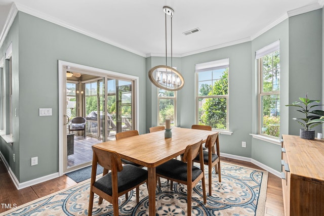 1523 Anthology Dr, Durham, NC 27703 - dining area with a chandelier, crown molding, and light wood-style floors