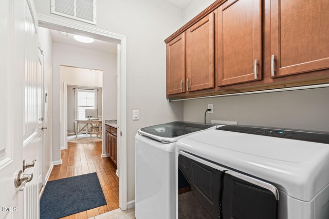 1523 Anthology Dr, Durham, NC 27703 - laundry room with separate washer and dryer, cabinet space, and light wood-type flooring