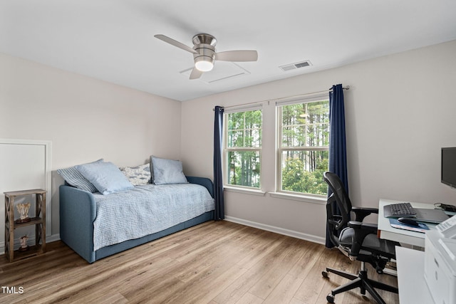 1523 Anthology Dr, Durham, NC 27703 - bedroom with light wood finished floors, an office area, and a ceiling fan