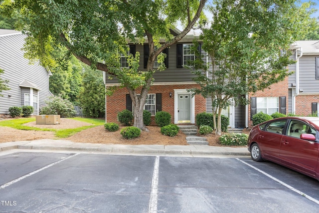 4406 Still Pines Dr, Raleigh, NC 27613 - view of property featuring uncovered parking and brick siding