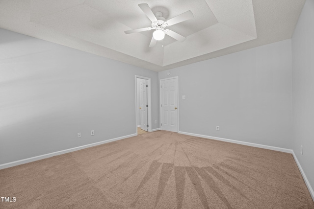 4406 Still Pines Dr, Raleigh, NC 27613 - unfurnished room featuring ceiling fan, light carpet, and a tray ceiling