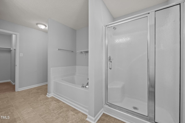 4406 Still Pines Dr, Raleigh, NC 27613 - bathroom with a stall shower, a garden tub, and a textured ceiling