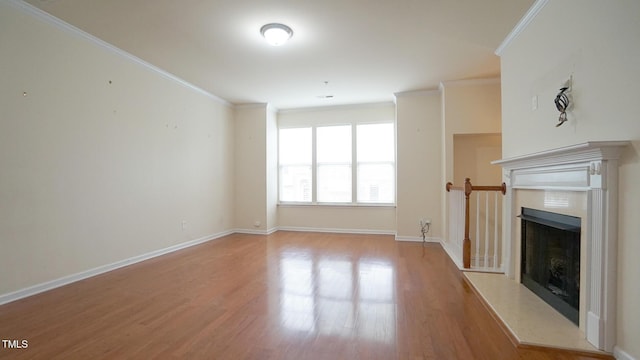5916 Longeria Ct, Raleigh, NC 27612 - unfurnished living room featuring ornamental molding, light wood finished floors, and a fireplace with raised hearth