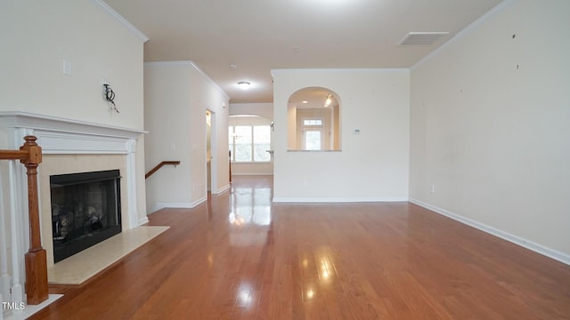5916 Longeria Ct, Raleigh, NC 27612 - unfurnished living room with wood finished floors, ornamental molding, arched walkways, and a fireplace