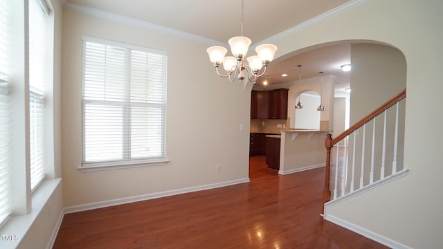 5916 Longeria Ct, Raleigh, NC 27612 - unfurnished dining area featuring arched walkways, ornamental molding, dark wood-type flooring, a chandelier, and stairway