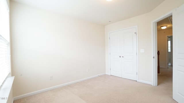 5916 Longeria Ct, Raleigh, NC 27612 - unfurnished bedroom featuring light colored carpet and a closet