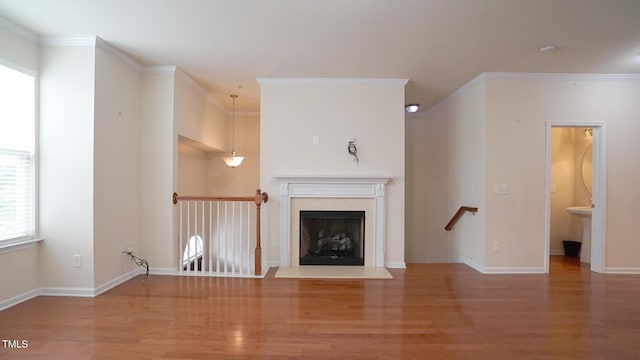 5916 Longeria Ct, Raleigh, NC 27612 - unfurnished living room featuring wood finished floors, ornamental molding, and a fireplace with flush hearth