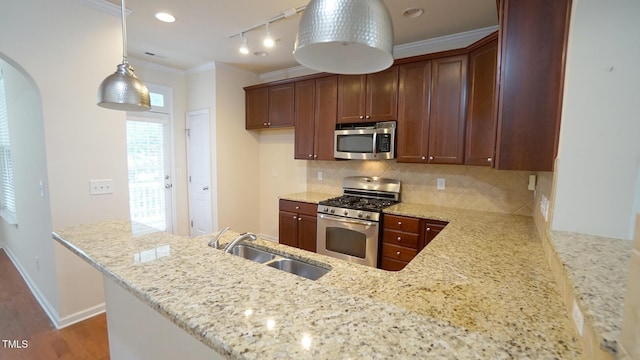 5916 Longeria Ct, Raleigh, NC 27612 - kitchen featuring stainless steel appliances, arched walkways, decorative backsplash, light stone countertops, and ornamental molding