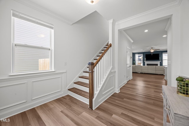 1600 Sandy Prairie Dr, Wendell, NC 27591 - stairway with ornamental molding, wood finished floors, a ceiling fan, a decorative wall, and recessed lighting