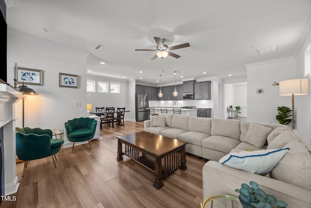 1600 Sandy Prairie Dr, Wendell, NC 27591 - living area featuring a ceiling fan, wood finished floors, crown molding, and recessed lighting