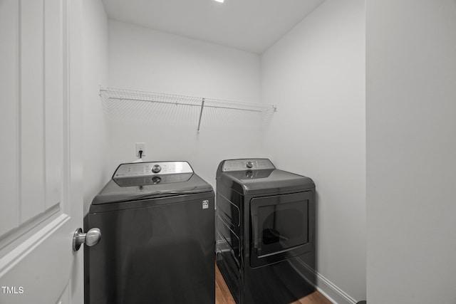 1600 Sandy Prairie Dr, Wendell, NC 27591 - laundry room featuring washer and clothes dryer and wood finished floors