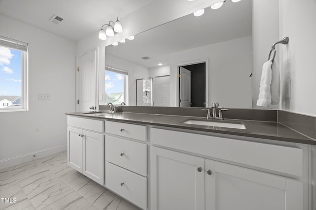 1600 Sandy Prairie Dr, Wendell, NC 27591 - bathroom featuring double vanity, marble finish flooring, and a stall shower