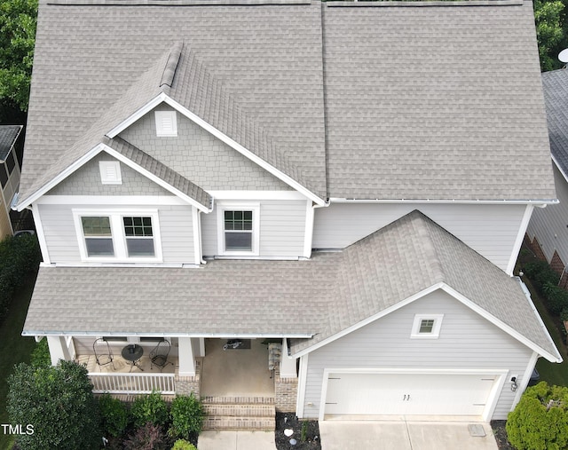 621 Ancient Oaks Dr, Holly Springs, NC 27540 - view of front of property featuring covered porch, a shingled roof, a garage, and driveway