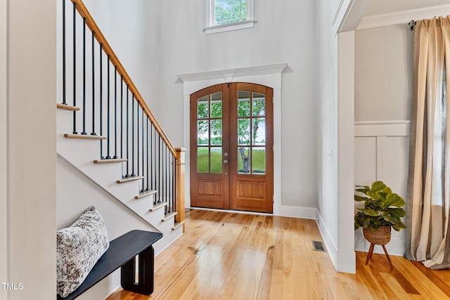 532 Joe Collins Rd, Lillington, NC 27546 - entryway featuring healthy amount of natural light, light wood finished floors, french doors, stairway, and a towering ceiling