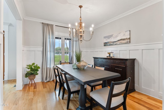 532 Joe Collins Rd, Lillington, NC 27546 - dining space with a decorative wall, a chandelier, a wainscoted wall, ornamental molding, and light wood finished floors