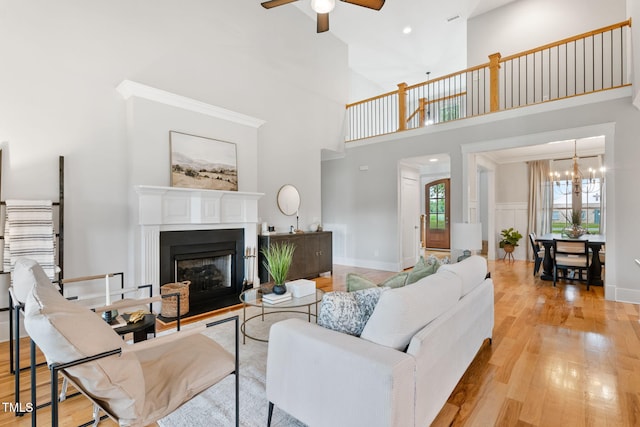 532 Joe Collins Rd, Lillington, NC 27546 - living area featuring ceiling fan, a high ceiling, wood finished floors, a chandelier, and a fireplace