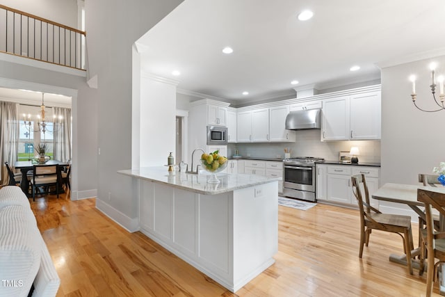 532 Joe Collins Rd, Lillington, NC 27546 - kitchen with stainless steel appliances, a chandelier, under cabinet range hood, tasteful backsplash, and ornamental molding