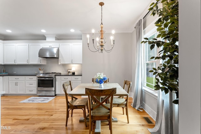 532 Joe Collins Rd, Lillington, NC 27546 - dining space with a chandelier, light wood-type flooring, and ornamental molding