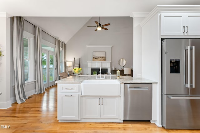 532 Joe Collins Rd, Lillington, NC 27546 - kitchen with stainless steel appliances, a ceiling fan, a peninsula, open floor plan, and light stone counters