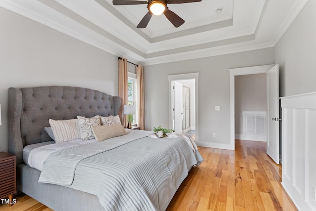 532 Joe Collins Rd, Lillington, NC 27546 - bedroom with light wood-type flooring, a tray ceiling, ceiling fan, and ornamental molding