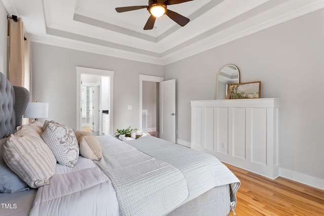 532 Joe Collins Rd, Lillington, NC 27546 - bedroom featuring light wood finished floors, a raised ceiling, and a ceiling fan