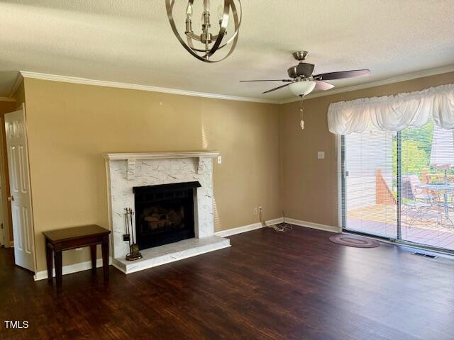 120 W Front St, Oxford, NC 27565 - unfurnished living room featuring wood finished floors, ornamental molding, a ceiling fan, a premium fireplace, and a chandelier