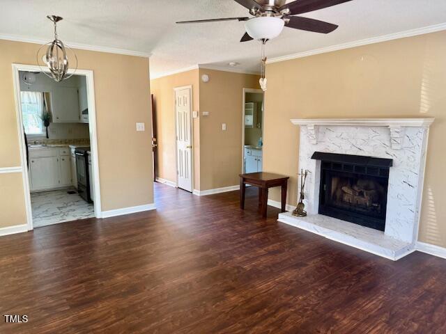 120 W Front St, Oxford, NC 27565 - unfurnished living room with ceiling fan, wood finished floors, crown molding, and a fireplace