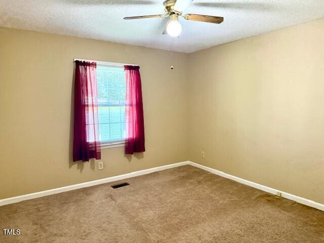 120 W Front St, Oxford, NC 27565 - empty room with a ceiling fan, carpet, and a textured ceiling