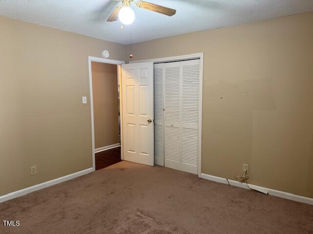 120 W Front St, Oxford, NC 27565 - unfurnished bedroom with carpet flooring, a closet, and ceiling fan