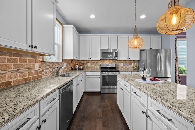 7 Faircroft Ct, Durham, NC 27703 - kitchen with stainless steel appliances, white cabinets, light stone countertops, pendant lighting, and recessed lighting