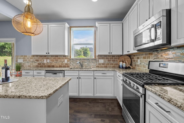 7 Faircroft Ct, Durham, NC 27703 - kitchen with appliances with stainless steel finishes, dark wood-type flooring, white cabinetry, light stone counters, and recessed lighting