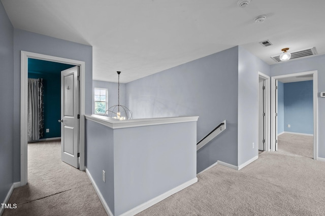 7 Faircroft Ct, Durham, NC 27703 - hallway with an upstairs landing, carpet floors, and a chandelier